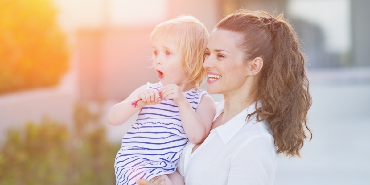 Model Mother Holds Child in Soft Light